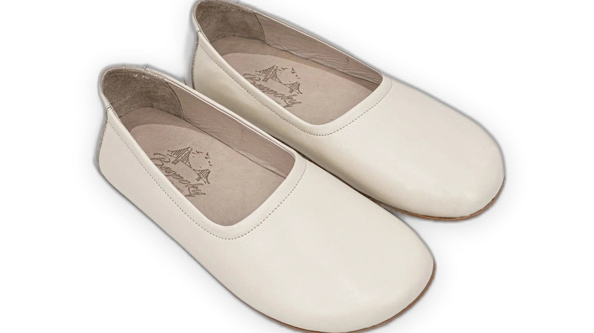 Cream handmade calf leather ballet flats with a wide anatomical toe box, shown from the side on a neutral background