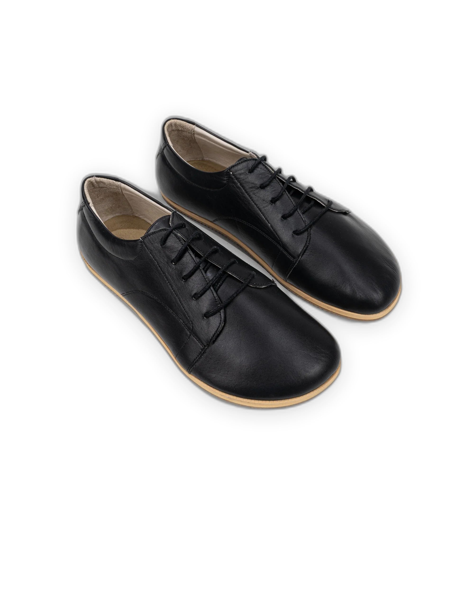 Black full-grain leather barefoot sneakers with a wide toe box and zero drop sole, worn daily to build foot strength
