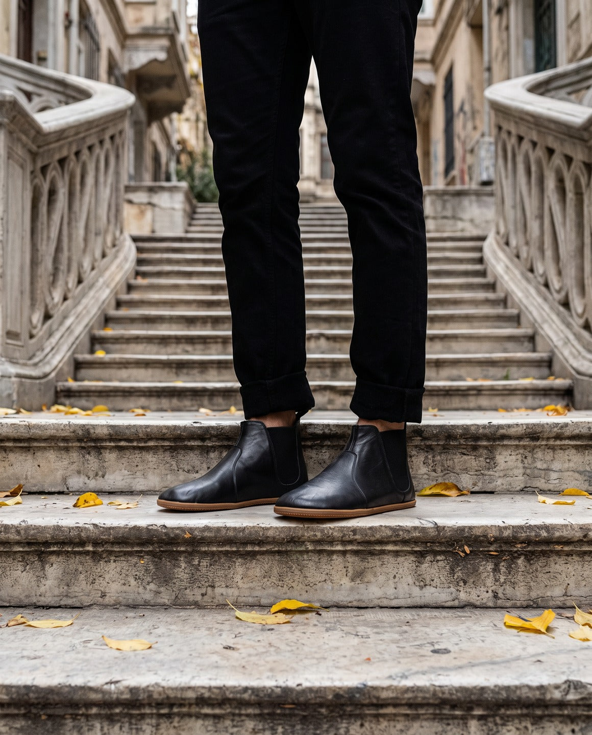 Men's black barefoot Chelsea boots on the old stone stairs of Galata, Istanbul (AI-assisted background, real Bespoky product) [S2-galata-chelsea_v1.png]