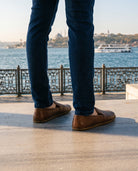 Men's brown barefoot shoes on the Bosphorus waterfront in Istanbul (AI-assisted background, real Bespoky product) [S5-bogaz-eminonu_v1.png]