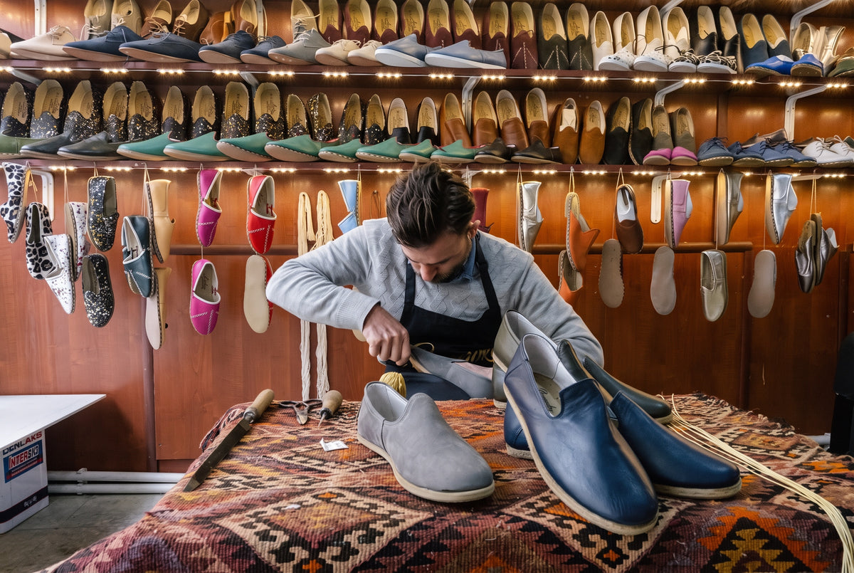 Bespoky craftsman stitching leather barefoot shoes in the Gaziantep workshop