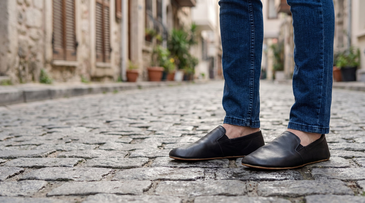 Black leather Eminonu barefoot shoes on an Istanbul cobblestone street